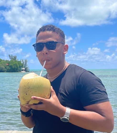 Photo of Cleve Drinking a coconut